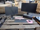 two monitors and a keyboard sitting on a pallet