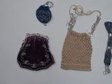 a purse, a purse chain, and other items laid out on a table