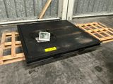 a black box sitting on a pallet in a warehouse