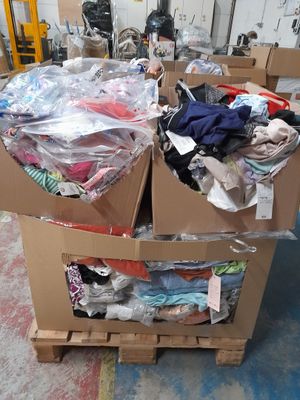 two boxes of clothing sitting on a pallet in a warehouse