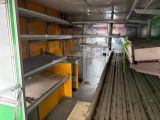 many shelves in the back of a green truck