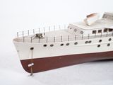 a model of a boat sitting on a white surface