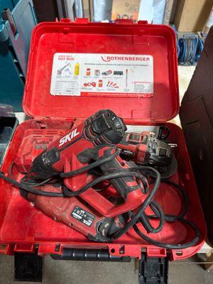 a red tool box with tools in it on a table