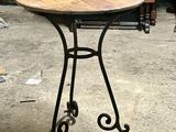 a small table with a wooden top in a room