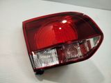 a close up of a red tail light on a white surface