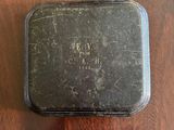 a small black box sitting on a wooden table