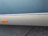 a close up of a car door with an orange knob