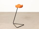 a small orange chair sitting on top of a metal stand