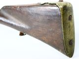 an old brass - plated rifle with a wooden handle