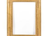 a gold frame on a white wall with a white background