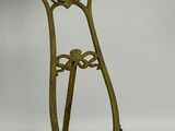 a metal stand with a clock on it on a white background