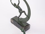 statue of a man holding a tennis racquet on a marble base