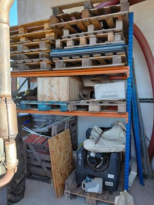 a large pile of assorted items in a garage