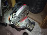 a circular saw sitting on the floor next to a tire