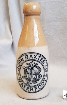 a small bottle with a logo on it sitting on a table