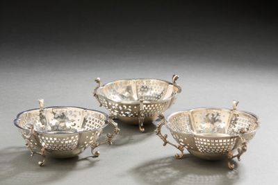 three silver plated bowls with handles and handles on a table
