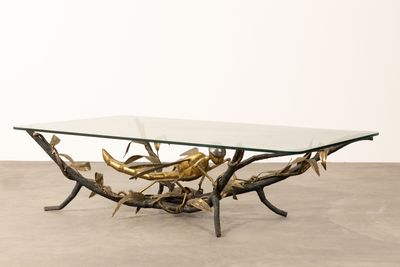 an image of a coffee table with a glass top and branches on it