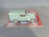 a green toy truck that is sitting on top of a box