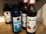 many bottles of liquor on a shelf in the kitchen