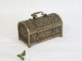 a small metal box with a handle on a white surface