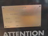 a sign on the side of a machine that says attention