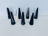 four black metal bells sitting on top of a white counter