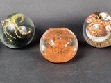 six different types of marbles sitting on a black surface