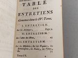 an open book on a white table with writing on it