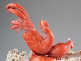 two birds sitting on top of a cake on a table