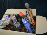 a cardboard box with a doll in it on a black background