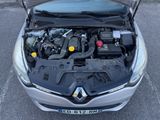 the engine of a car with its hood open in a parking lot