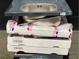 a stack of boxes and pans sitting on a pallet