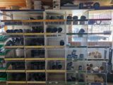 many shelves with pots and pans on them in a room