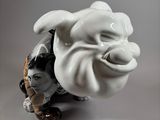 a figurine of a man sitting on the ground