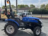 a blue tractor that is parked in the parking lot