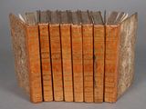 several old books stacked on top of each other on a table