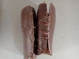 a pair of brown boots with laces on them