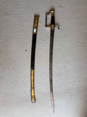 two swords that are laying on a table
