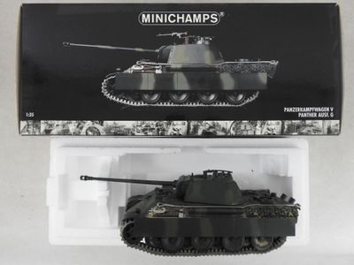 a toy tank that is sitting on a white surface