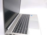 a silver laptop computer sitting on a white surface