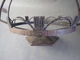 a metal basket that has a metal handle on it