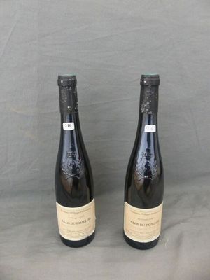 two bottles of wine sitting on top of a table next to each other
