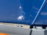 a close up of a car ' s bumper with a hole in it