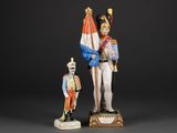 two figurines of a soldier and a soldier with a flag