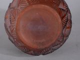 a brown glass bowl with a design on it