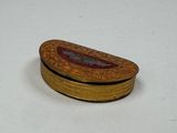 a small wooden box with a red and gold design on it
