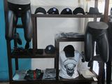 a room with a shelf with a bunch of hats on it