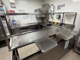 a large kitchen with stainless steel counter tops and stainless steel cabinets