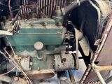 an old car engine sitting in the back of a truck
