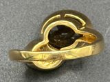 a gold ring with a black stone in it
